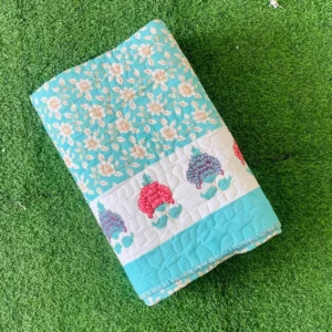 Exquisite print in blue and pink quilted, reversible bedcover for single bed