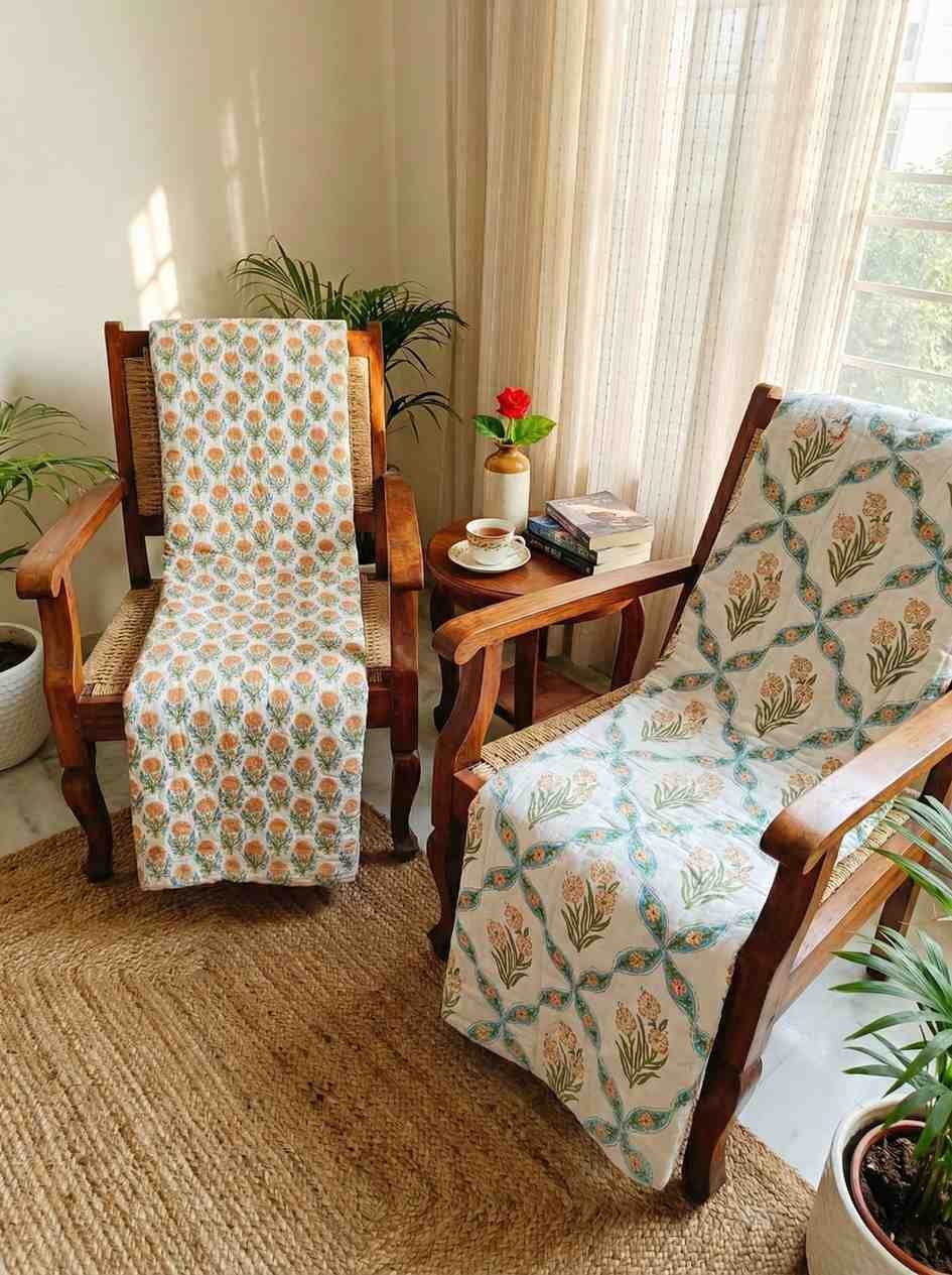 A pair of two single beautiful exquisite jaipur razais in floral booti and jaal design on premium cotton mulmul in orange and turquoise on white