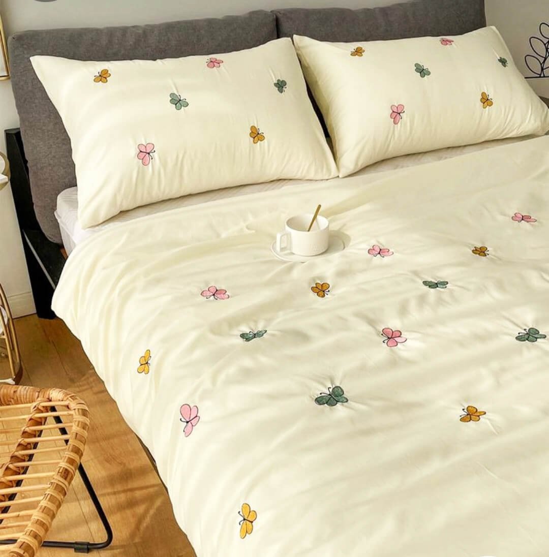 Exquisite embroidered bedsheet in multicolour butterfly pattern on light yellow premium cotton bedsheet with two pillow covers