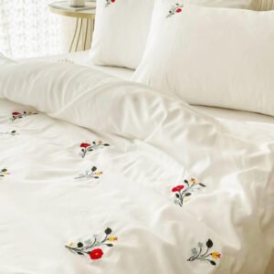 Exquisite embroidered bedsheet with red and yellow floral pattern on white in premium cotton bedsheet along with two pillow covers