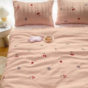 Exquisite embroidered bedsheet in red cherry and green-blue leaf pattern on peach premium cotton bedsheet with two pillow covers