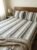 Elegant striped design in grey, beige and white on cotton handloom double bedsheet with two pillow covers