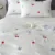 Exquisite embroidered cotton bedsheet with red cherry and green-blue leaf pattern on white in premium cotton bedsheet and two pillow covers